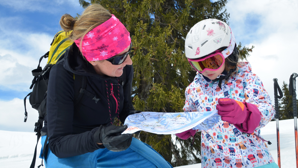 Julie Slaughter and her daughter dressed in ski attire.